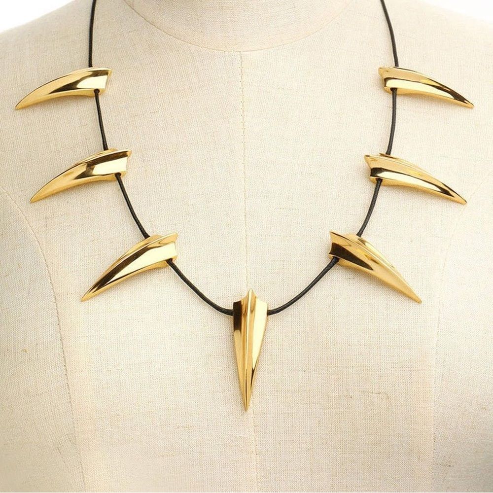 Modernist gold tone statement necklace featuring sculptural spike shaped element